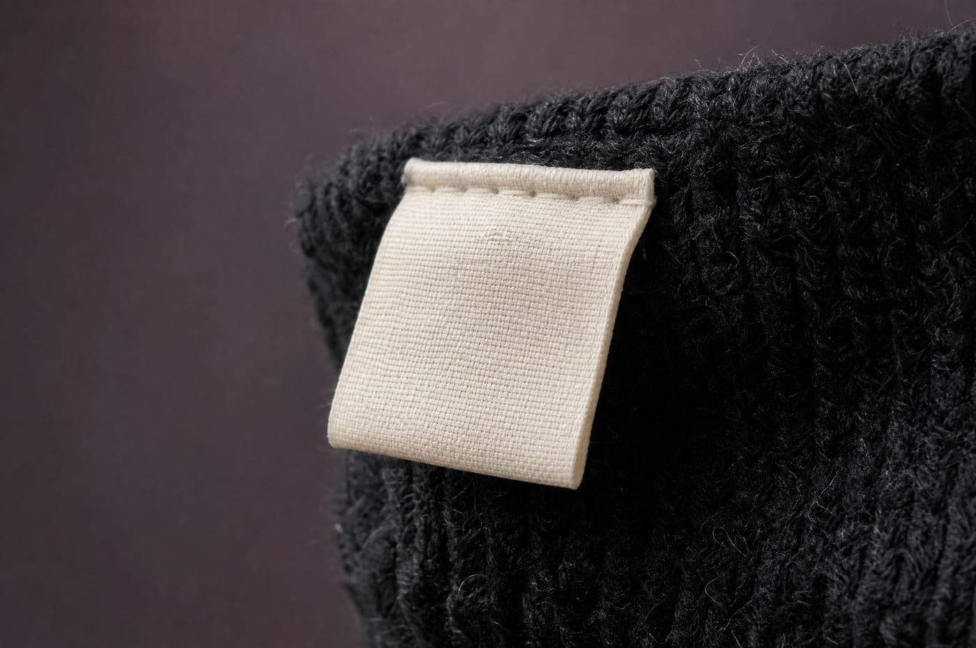 Photograph of the sewn-in fibre composition label for Knee 70 Wool-Blend